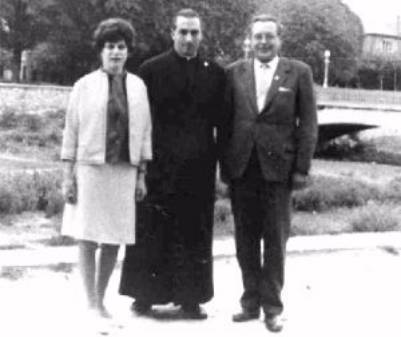 Three people posing outdoors in black-and-white.