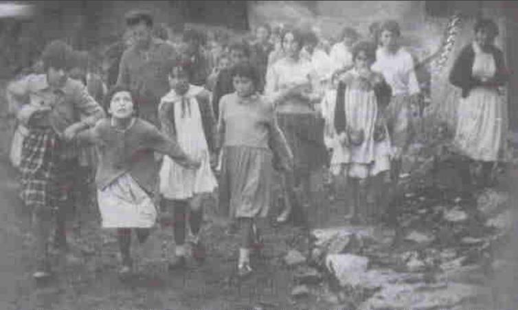 Group of children walking on rocky path.