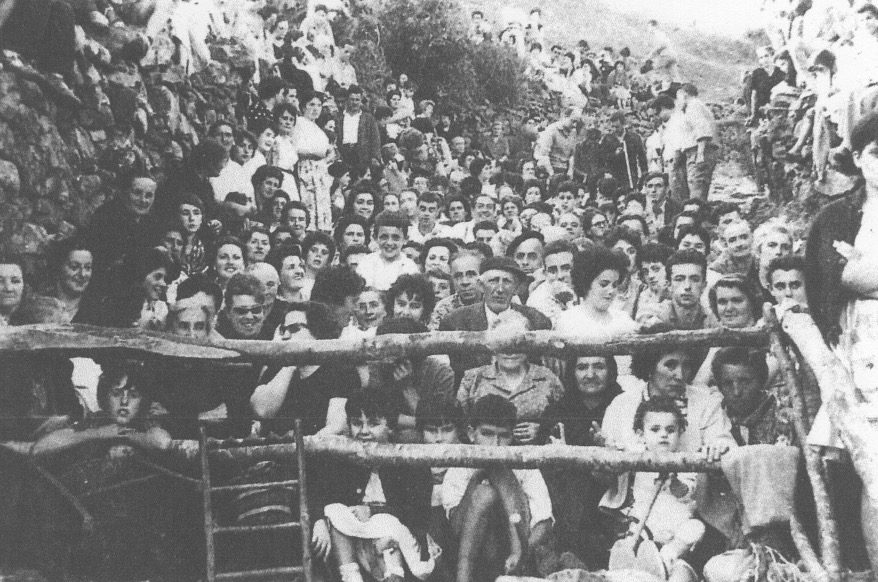 Crowd gathered on hillside, vintage photograph.