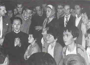 Group of people gathered, listening intently.