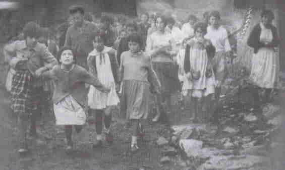 Group of children walking outdoors together.